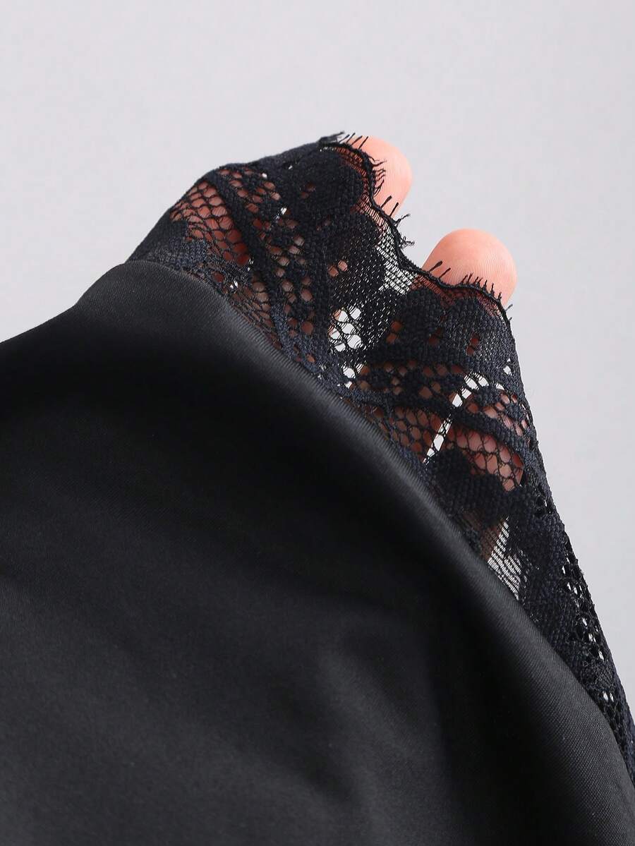 Women's black strapless lace patchwork bodycon mini dress featuring a slim fit design and an asymmetrical hem.
