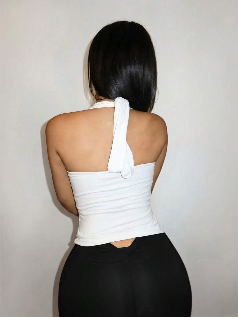 Women's cut out backless halter camisole top featuring a slim fit knitted design and front knot detail.