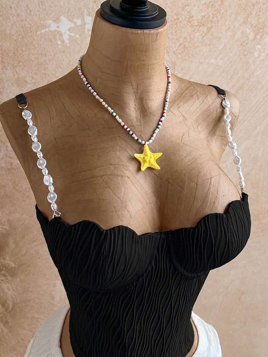 Women's black molded cup camisole top with scallop detailing and spaghetti straps.