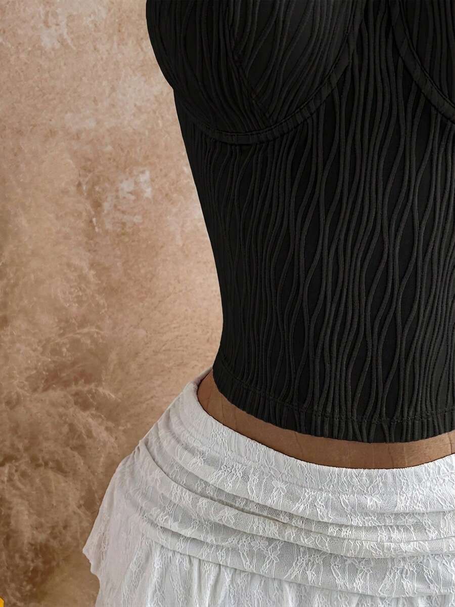 Women's black molded cup camisole top with scallop detailing and spaghetti straps.