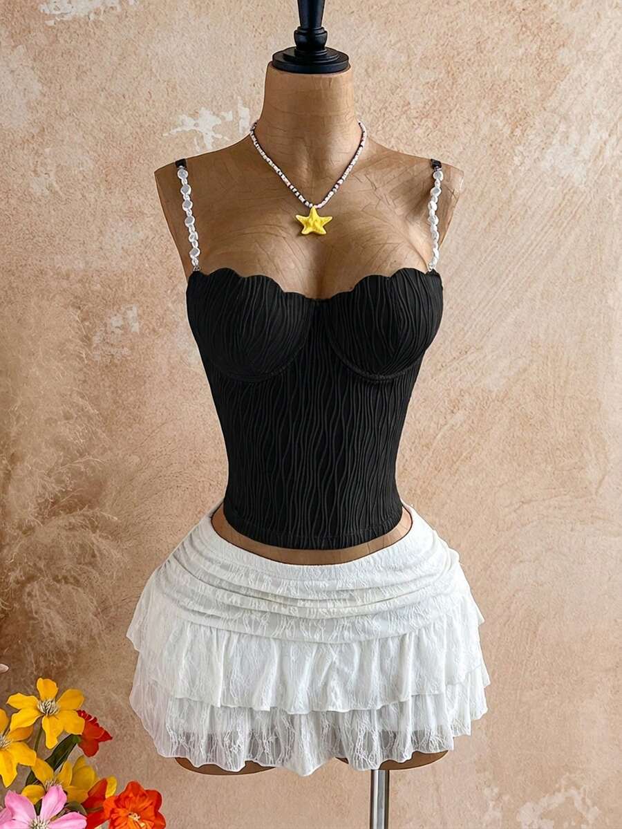 Women's black molded cup camisole top with scallop detailing and spaghetti straps.