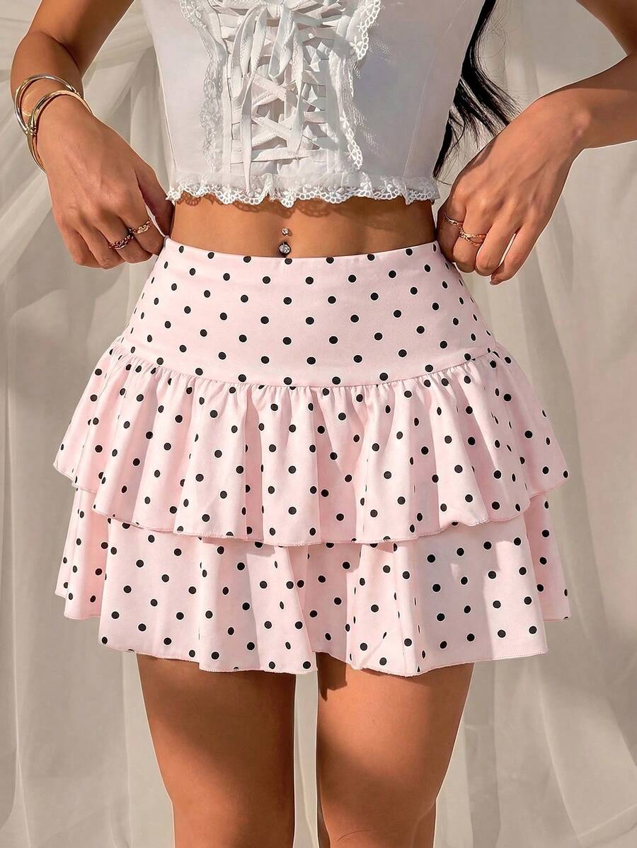 Black low waist knit mini skirt featuring a tiered ruffle hem and skinny high stretch fit.