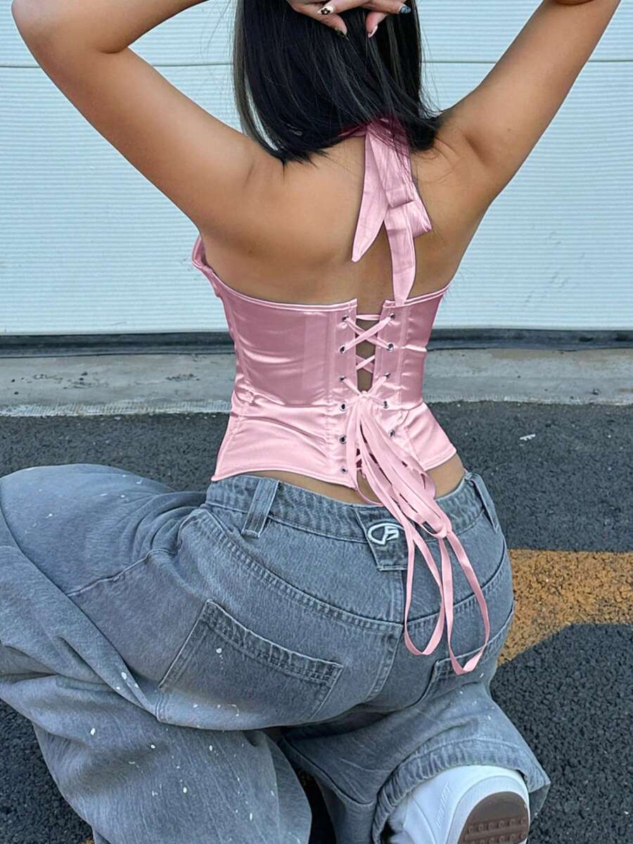 White satin corset crop top featuring a halter neck, slim fit, and back lace-up design.