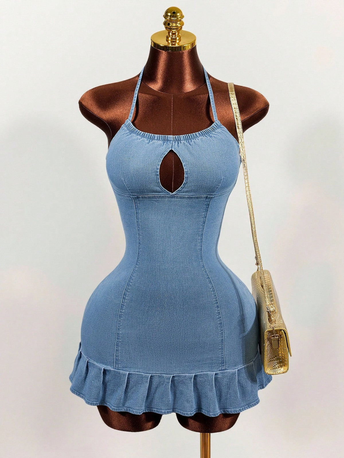 Women's blue denim halter mini dress featuring front cut-out details and a flounce ruffle hem.