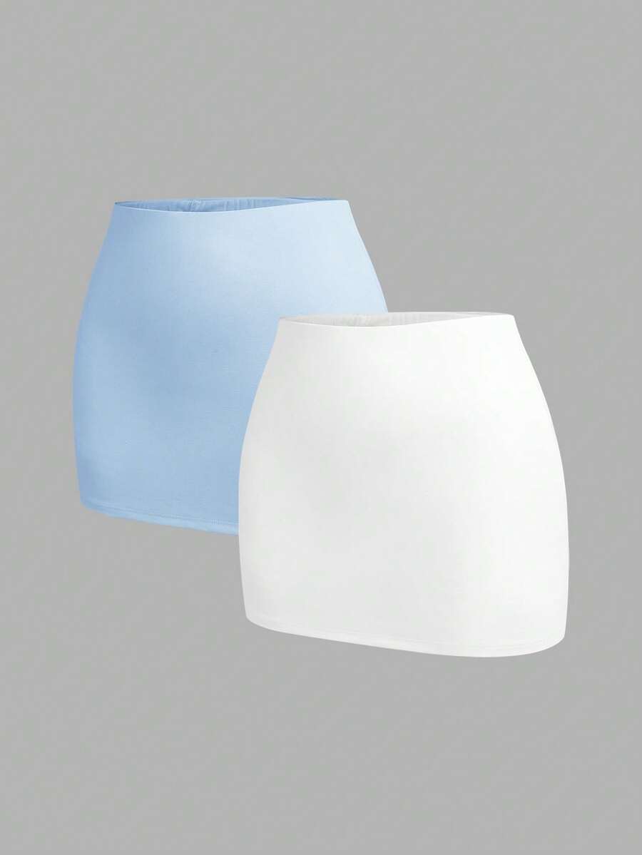 Women's black casual low rise bodycon mini skort with built-in shorts in knitted plain stretch fabric.