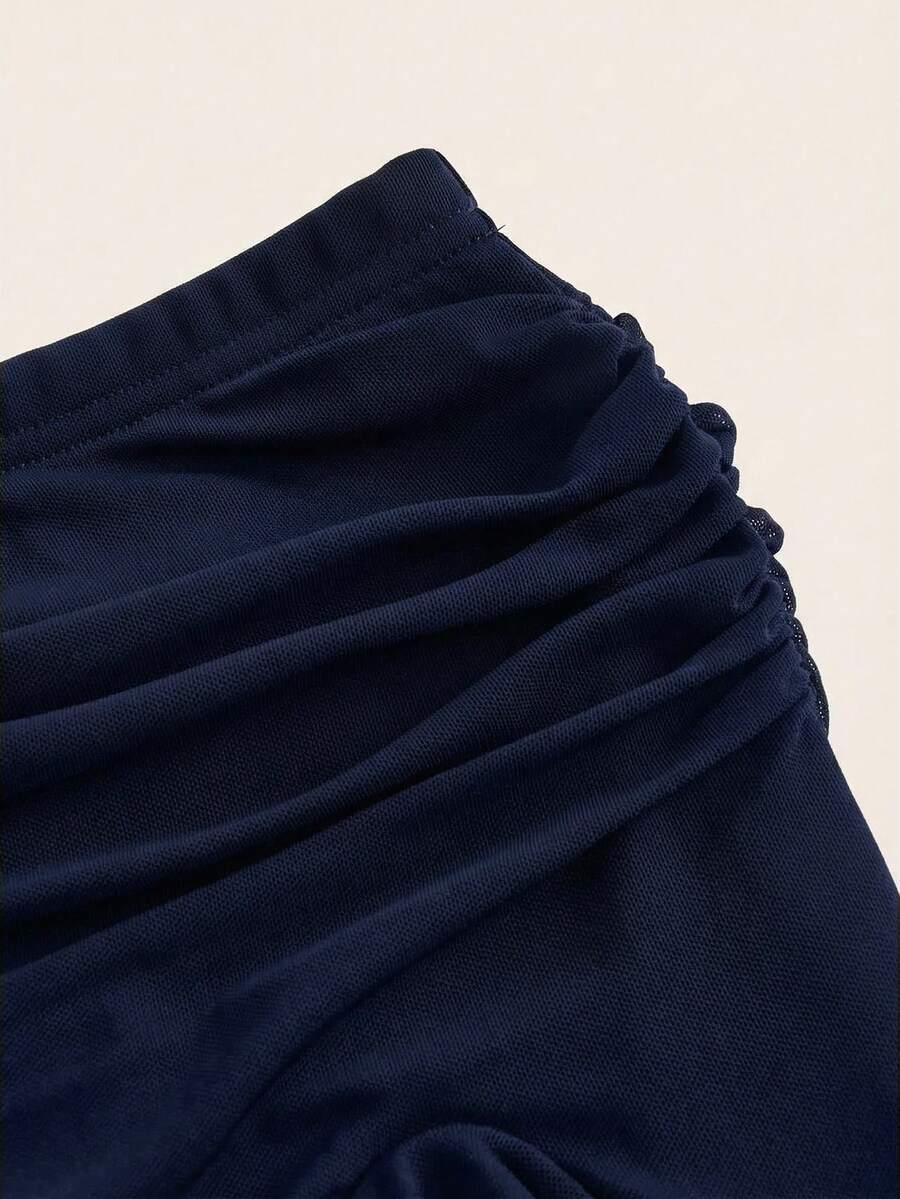 Women's black low rise asymmetrical midi skirt with ruched mesh fabric and layered ruffle hem