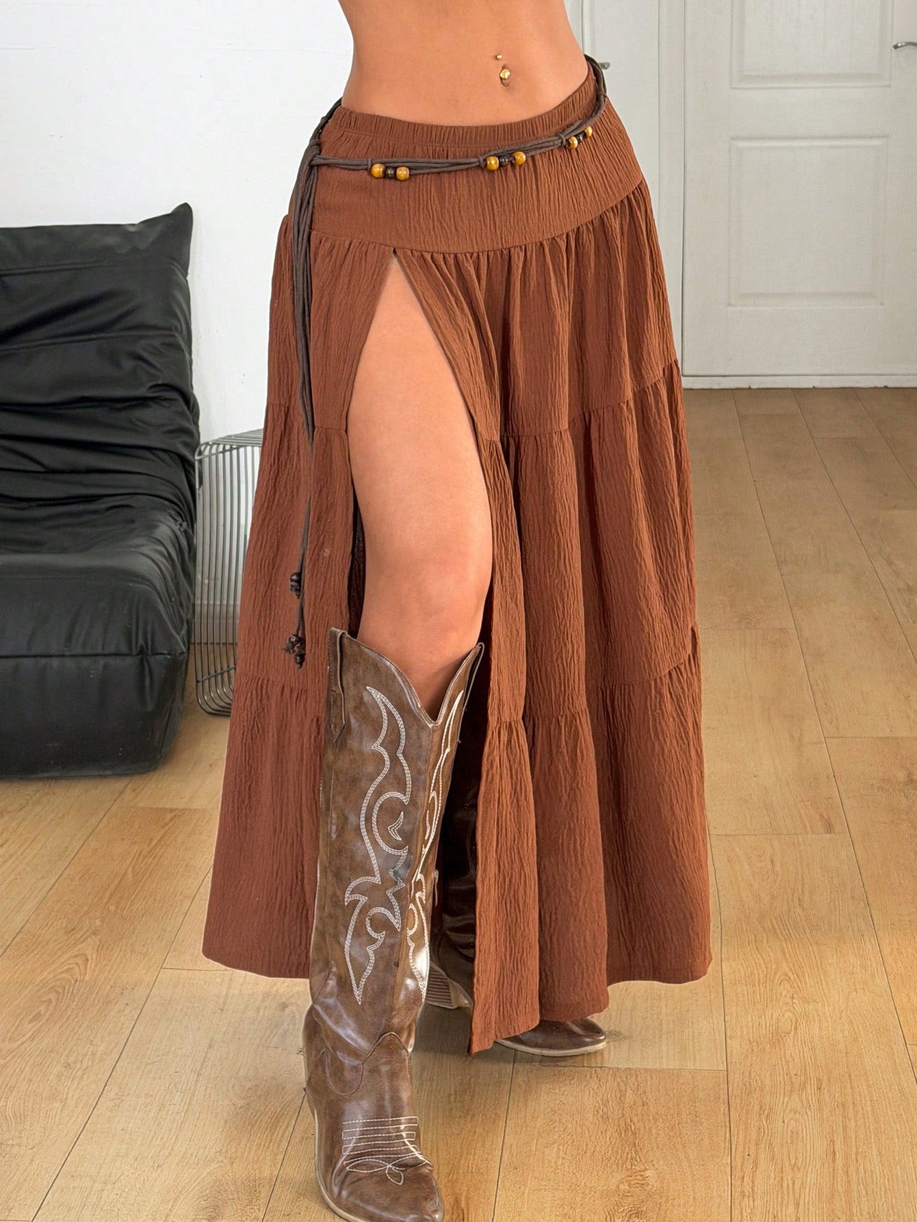 Women's black low waist split thigh long skirt featuring semi-sheer textured fabric and a flared skinny fit.