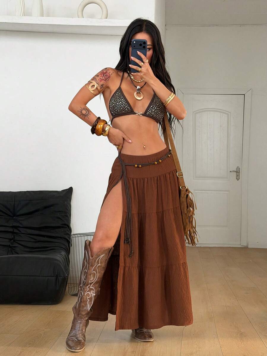 Women's black low waist split thigh long skirt featuring semi-sheer textured fabric and a flared skinny fit.