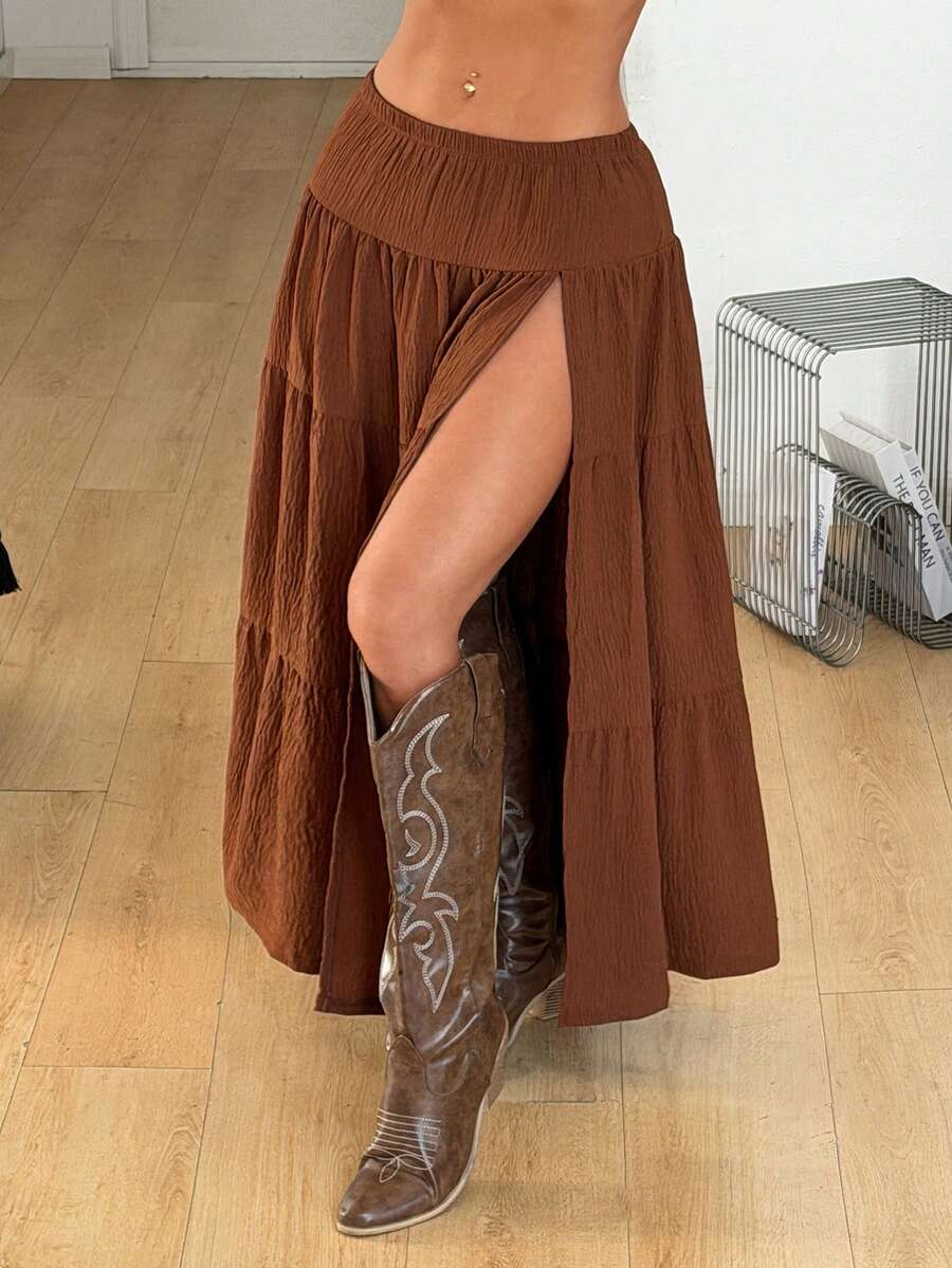Women's black low waist split thigh long skirt featuring semi-sheer textured fabric and a flared skinny fit.