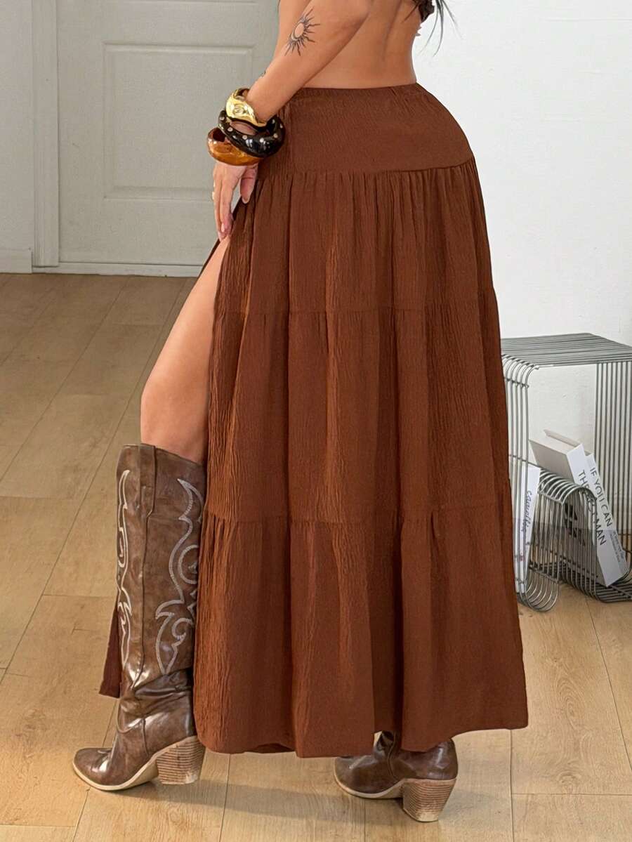 Women's black low waist split thigh long skirt featuring semi-sheer textured fabric and a flared skinny fit.