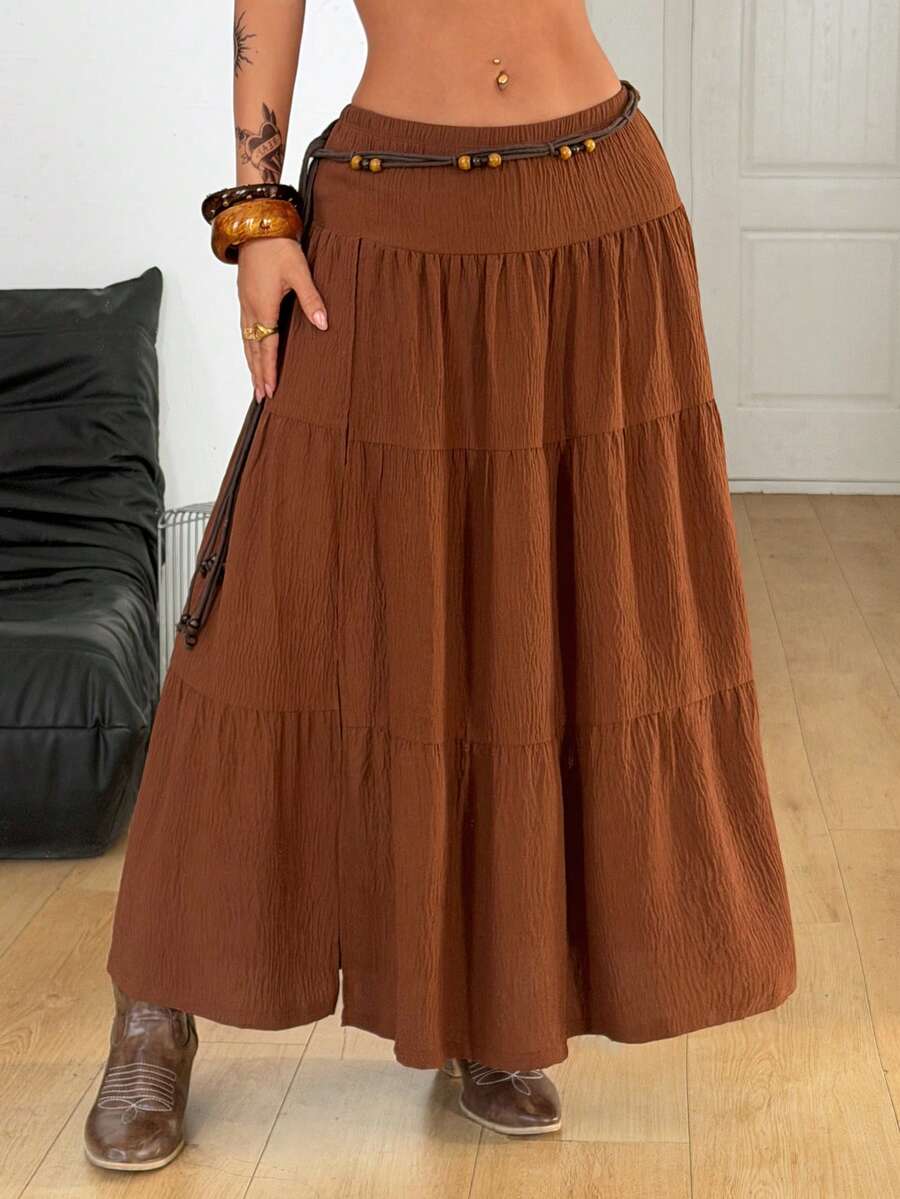 Women's black low waist split thigh long skirt featuring semi-sheer textured fabric and a flared skinny fit.