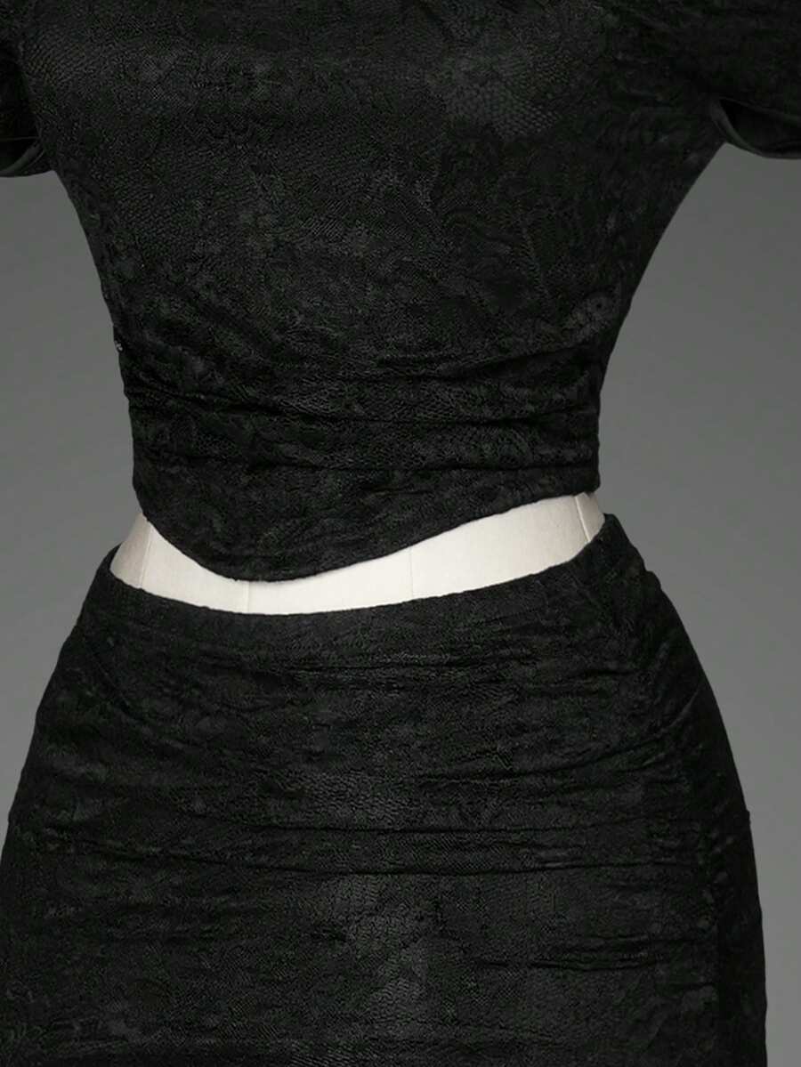 Black two-piece outfit set for women featuring an off-the-shoulder lace short sleeve top and a matching ruched asymmetrical short skirt.