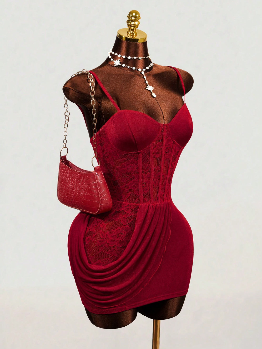 Red sleeveless cami mini dress with spaghetti straps, boned structure, and a slim fit pencil hem.