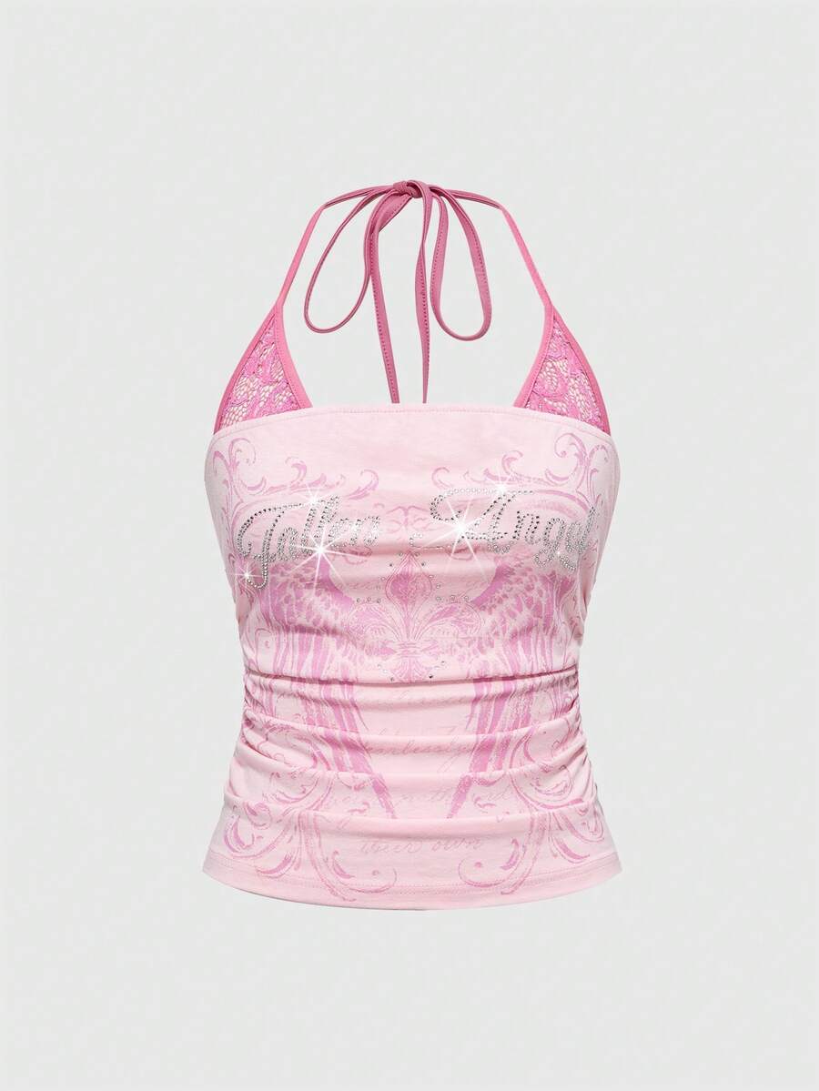 Woman wearing a black Y2K concert print 2-in-1 contrast lace halter crop top featuring a backless design with knot details.