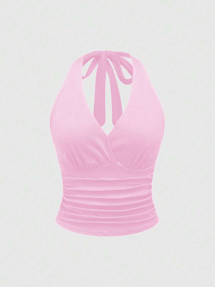 Women's halter crop tank top featuring a backless silhouette and ruched detailing in a slim fit design.