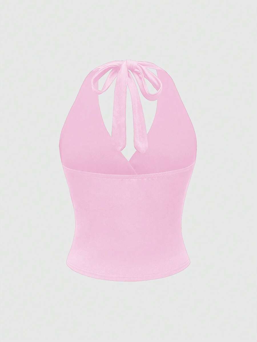 Women's halter crop tank top featuring a backless silhouette and ruched detailing in a slim fit design.