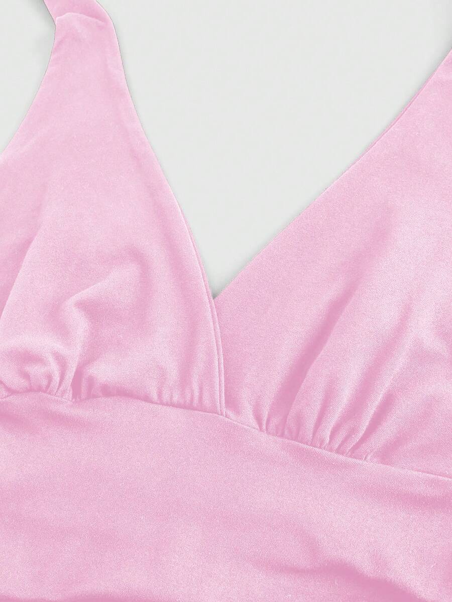 Women's halter crop tank top featuring a backless silhouette and ruched detailing in a slim fit design.