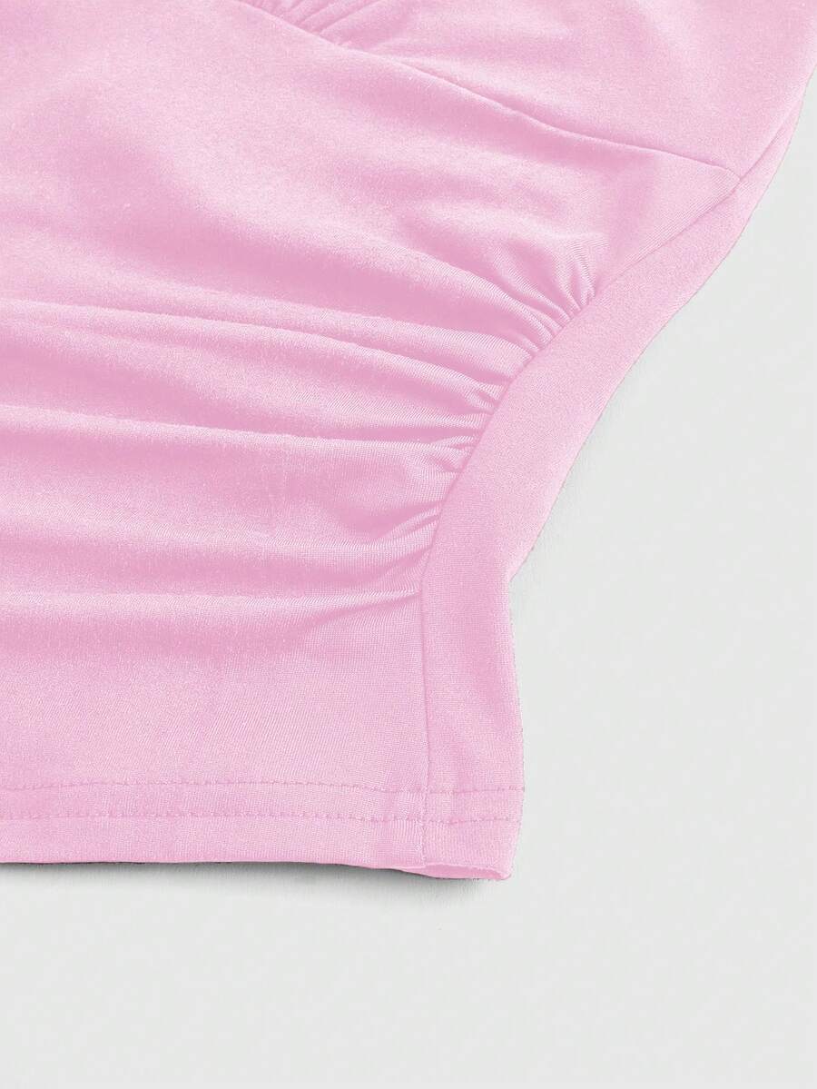 Women's halter crop tank top featuring a backless silhouette and ruched detailing in a slim fit design.
