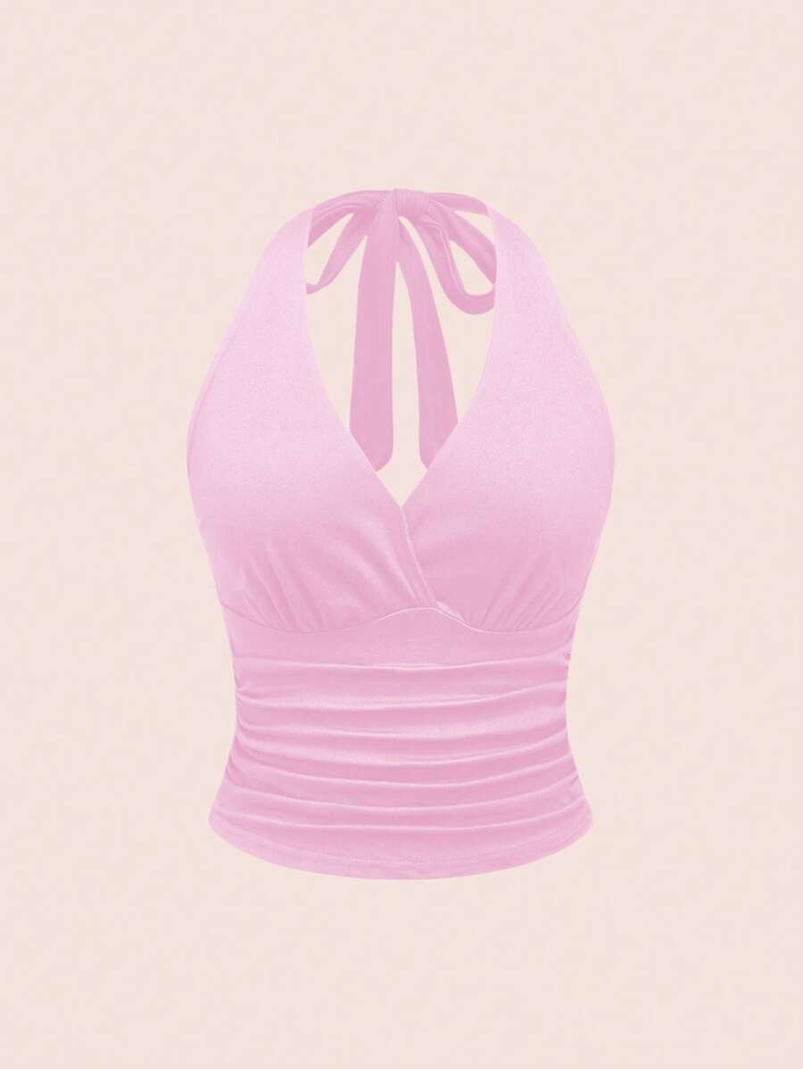 Women's halter crop tank top featuring a backless silhouette and ruched detailing in a slim fit design.