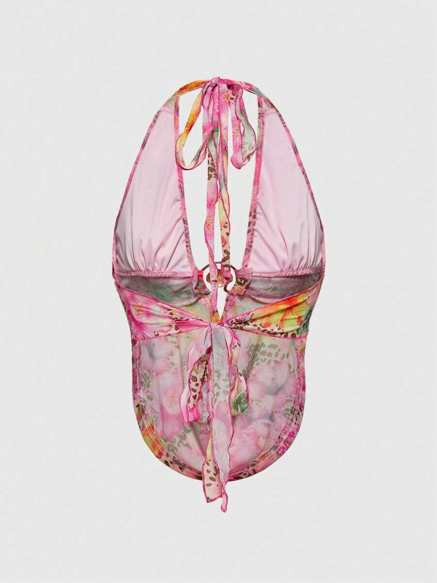 Women's pink backless halter top with rhinestone decor, knot detail, and asymmetrical hem.