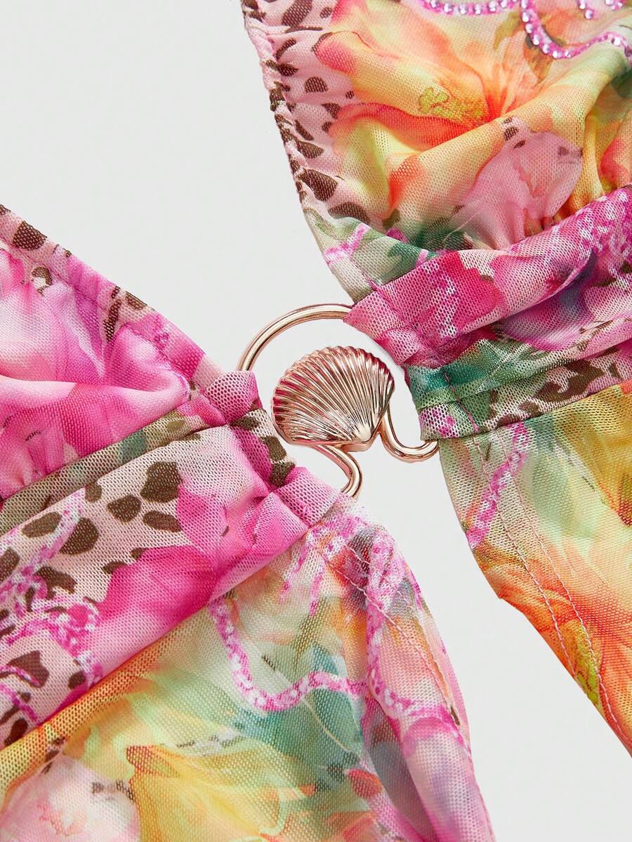 Women's pink backless halter top with rhinestone decor, knot detail, and asymmetrical hem.