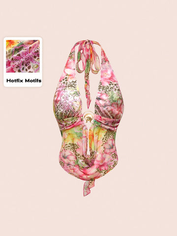 Women's pink backless halter top with rhinestone decor, knot detail, and asymmetrical hem.