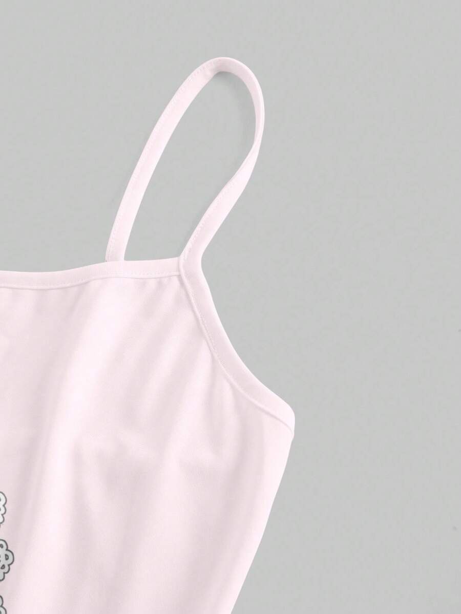 Women's black backless cami mini dress featuring spaghetti straps, lettuce trim detail, high waist, and a flared hem design.