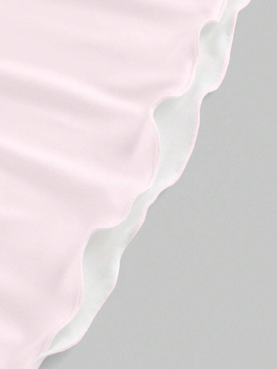 Women's black backless cami mini dress featuring spaghetti straps, lettuce trim detail, high waist, and a flared hem design.
