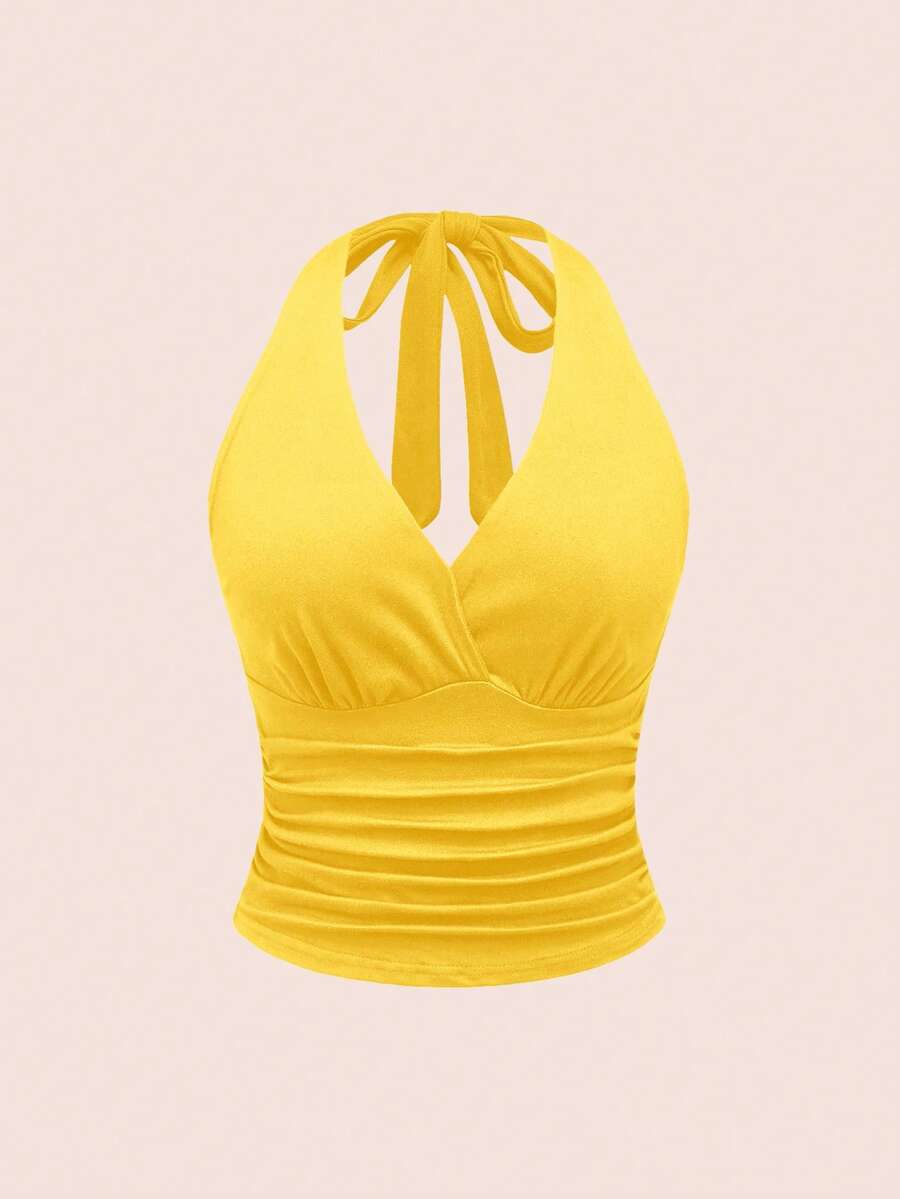 Women's halter crop tank top featuring a backless silhouette and ruched detailing in a slim fit design.