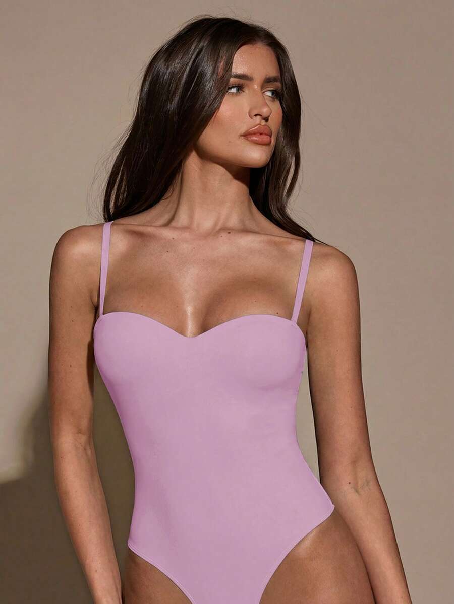 Apricot women's lace sheer camisole top featuring spaghetti straps, contrast lace trim, backless slim fit design, and knitted stretch fabric.