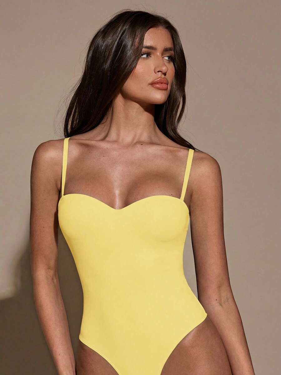 Apricot women's lace sheer camisole top featuring spaghetti straps, contrast lace trim, backless slim fit design, and knitted stretch fabric.