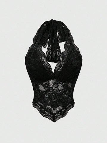 Women's black lace halter neck camisole featuring a backless crop silhouette, contrast lace trim, and scallop hem.