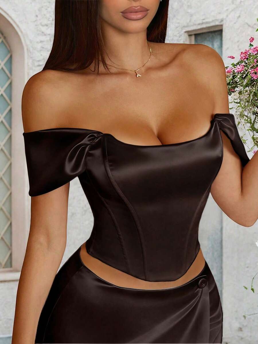 Women's white satin corset crop top with off-shoulder neckline, backless cut, and asymmetrical hem.