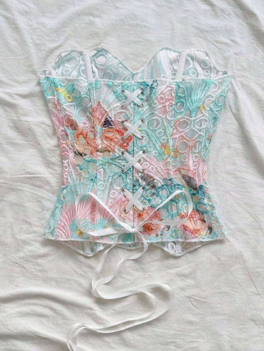 Strapless floral corset top with lace-up detail, asymmetrical hem, and slim fit for women in a boho vacation style.