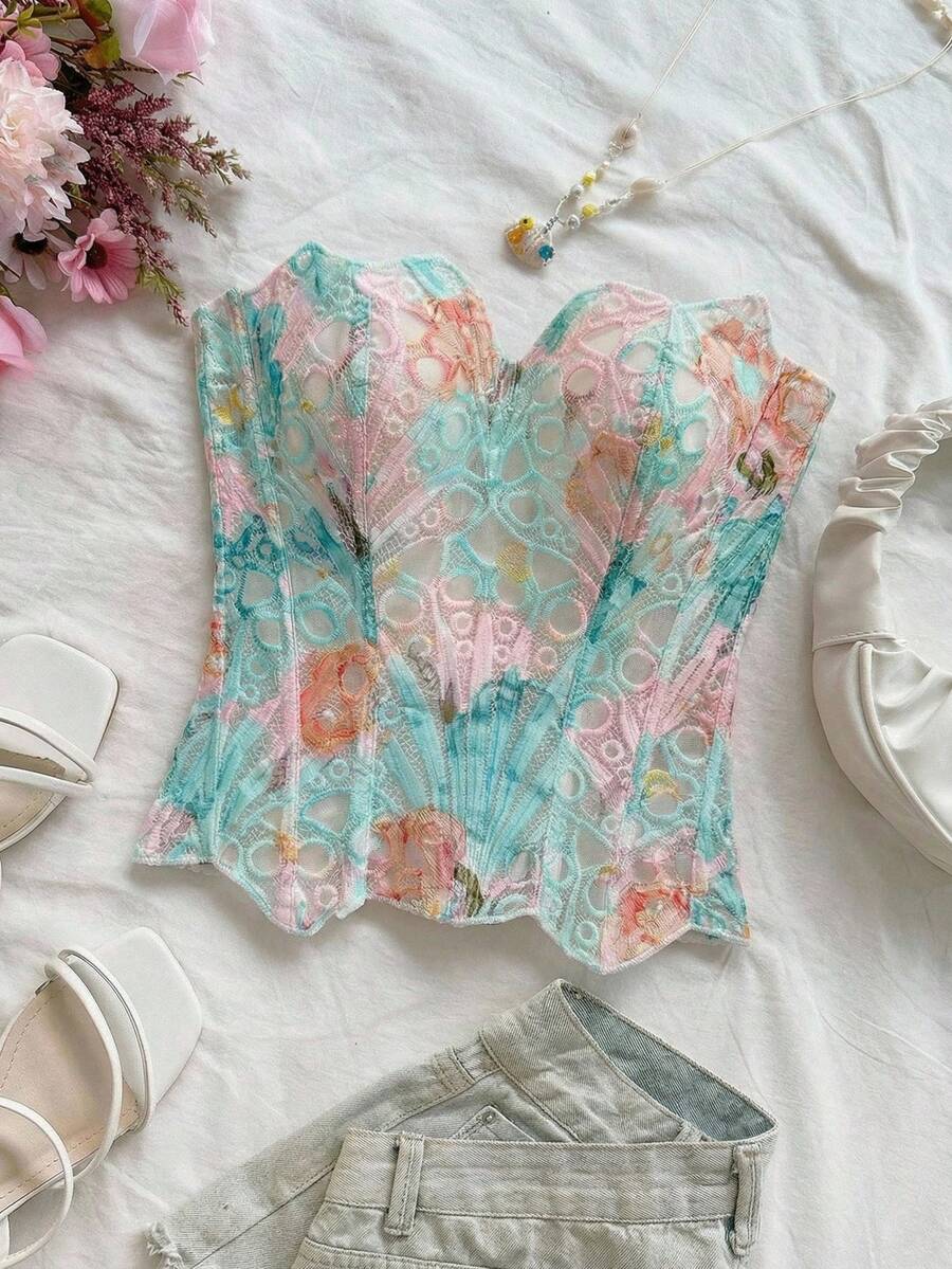 Strapless floral corset top with lace-up detail, asymmetrical hem, and slim fit for women in a boho vacation style.