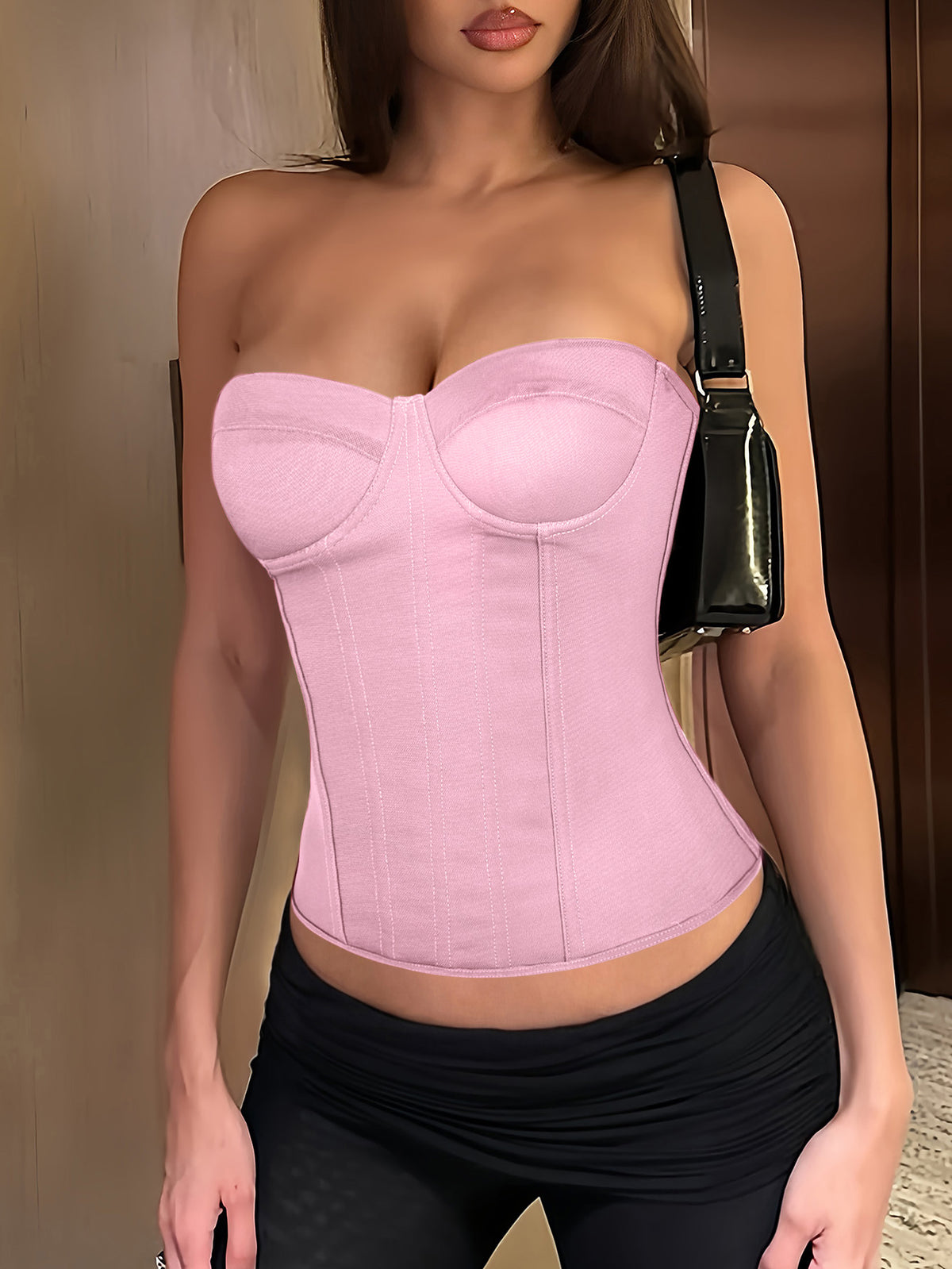 Black strapless corset top with boning, lace-up back, and a cropped slim-fit silhouette for women.