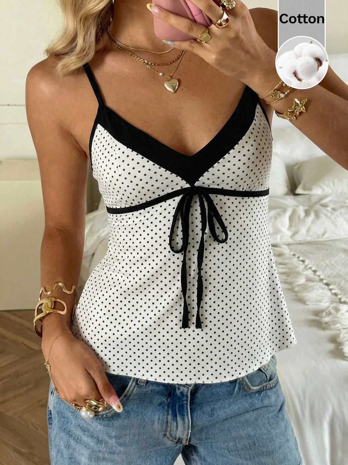 Black and white polka dot tie strap camisole top for women with thin spaghetti straps and slim fit.