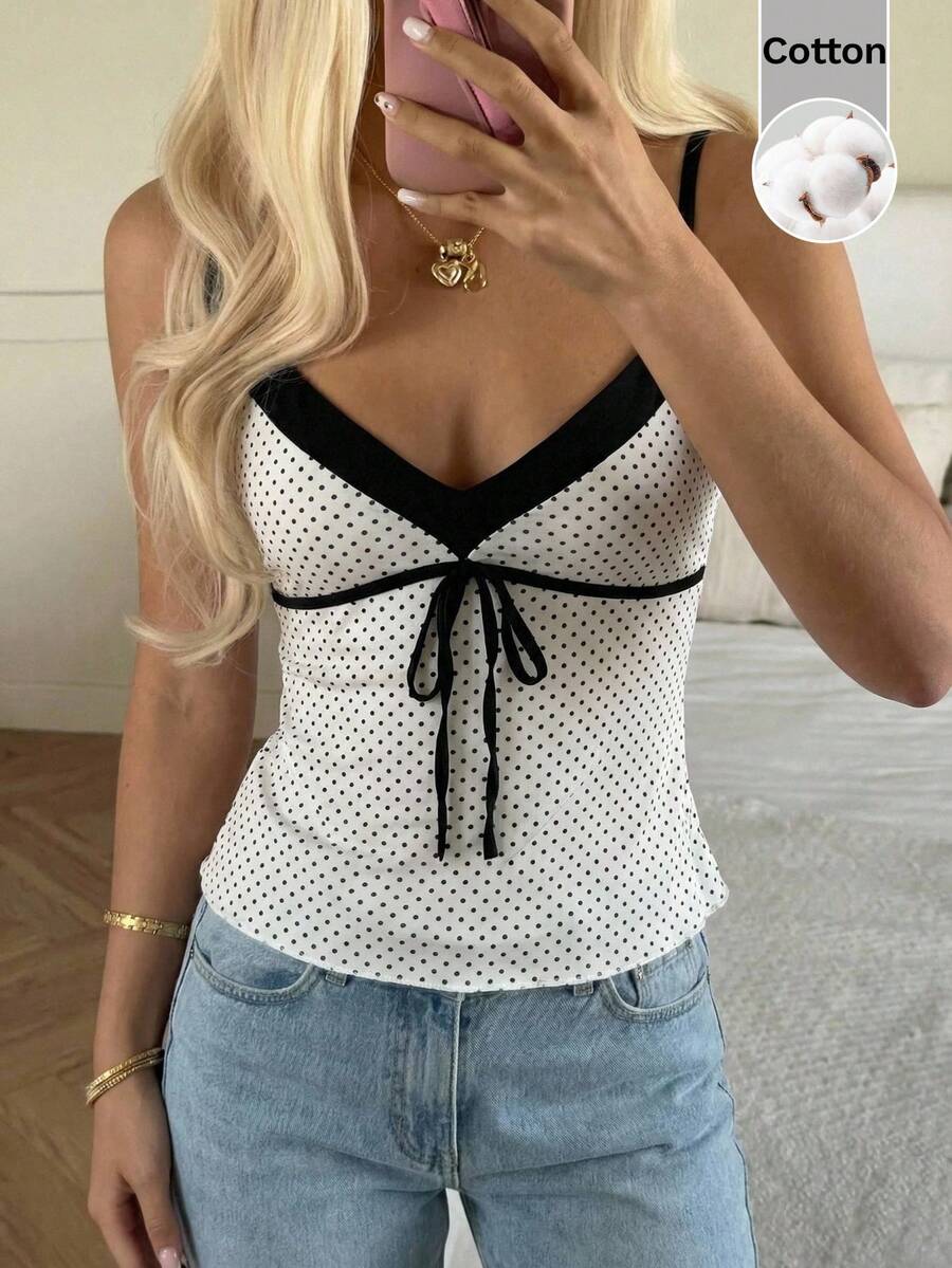 Black and white polka dot tie strap camisole top for women with thin spaghetti straps and slim fit.