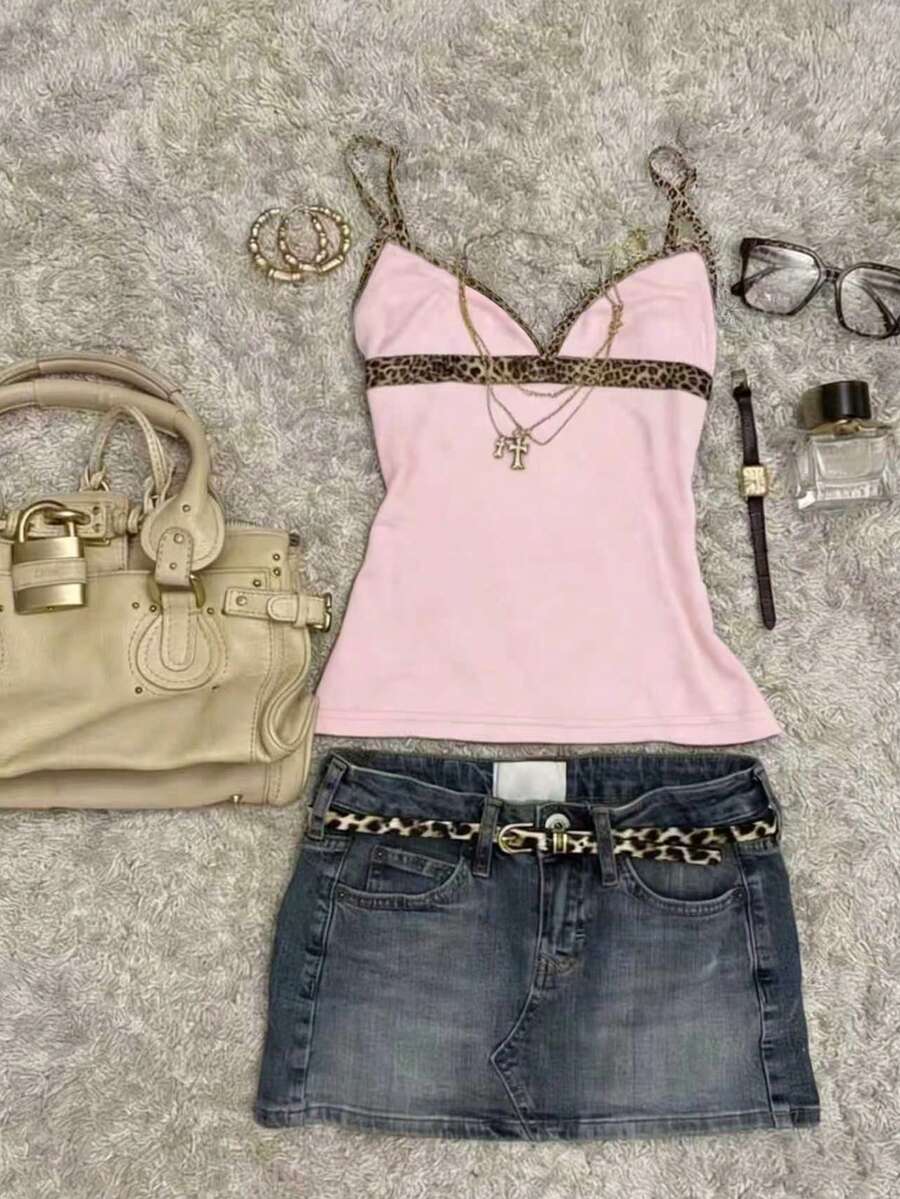 A women's solid slim fit camisole top with delicate contrast lace trim around the neckline and spaghetti straps.