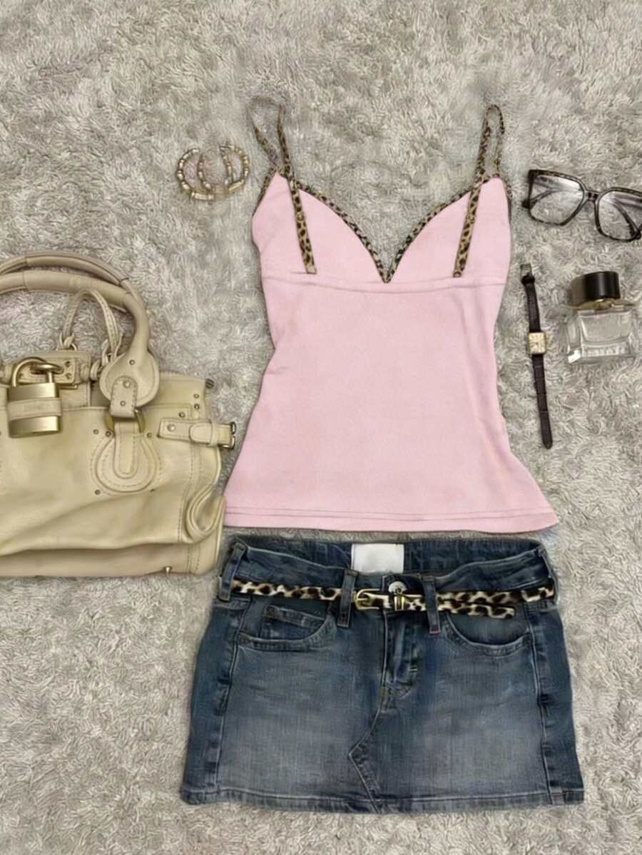 A women's solid slim fit camisole top with delicate contrast lace trim around the neckline and spaghetti straps.