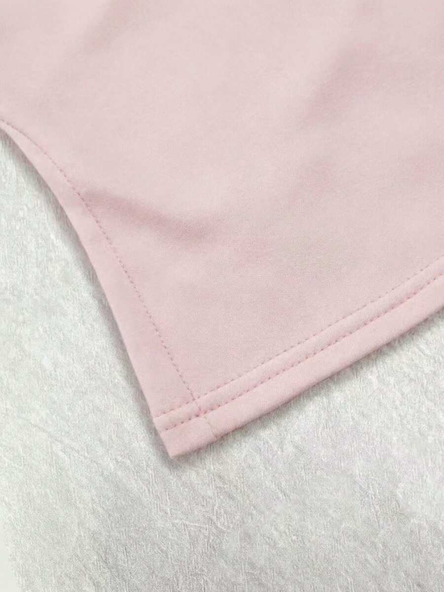 A women's solid slim fit camisole top with delicate contrast lace trim around the neckline and spaghetti straps.