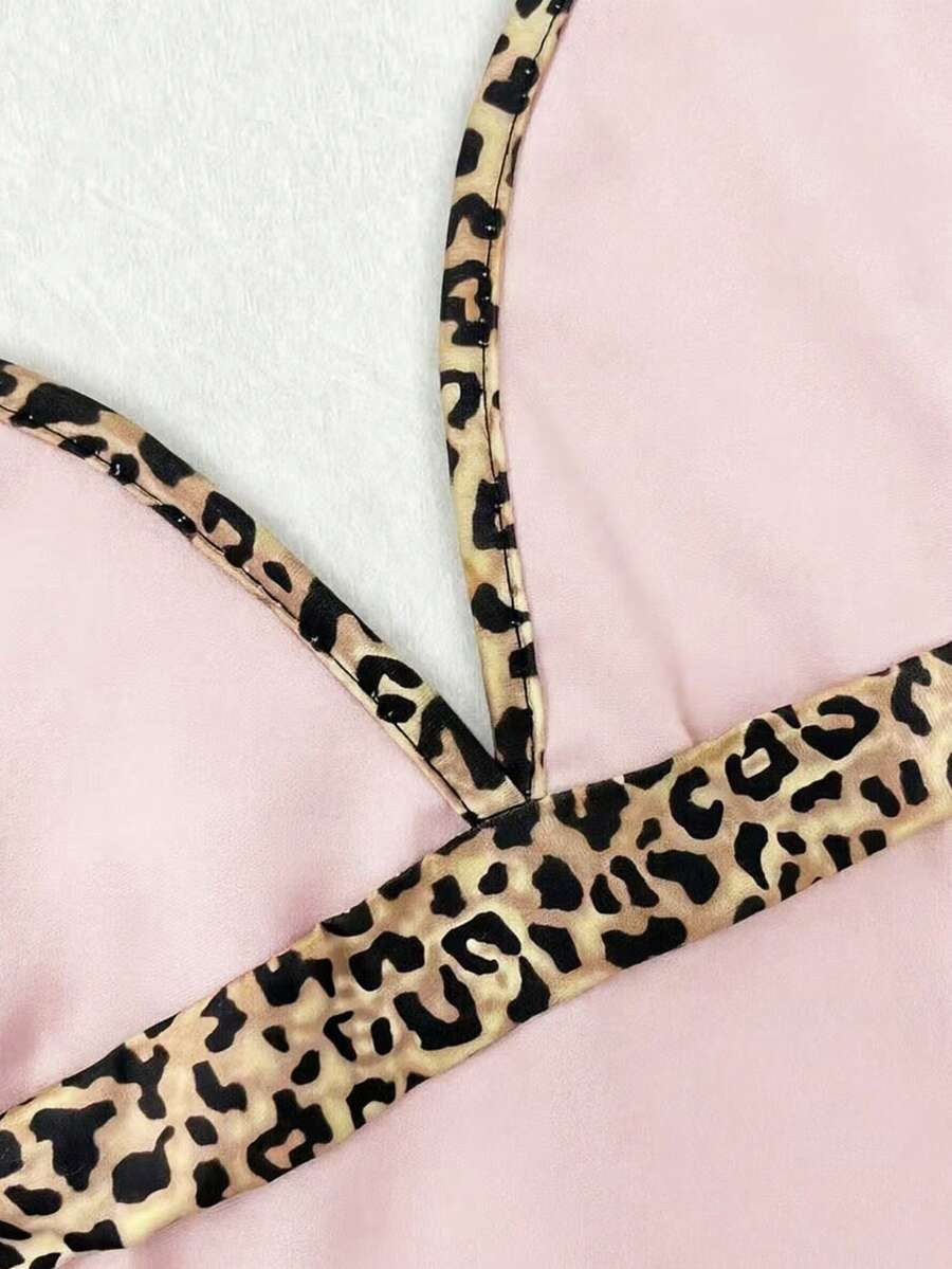 A women's solid slim fit camisole top with delicate contrast lace trim around the neckline and spaghetti straps.