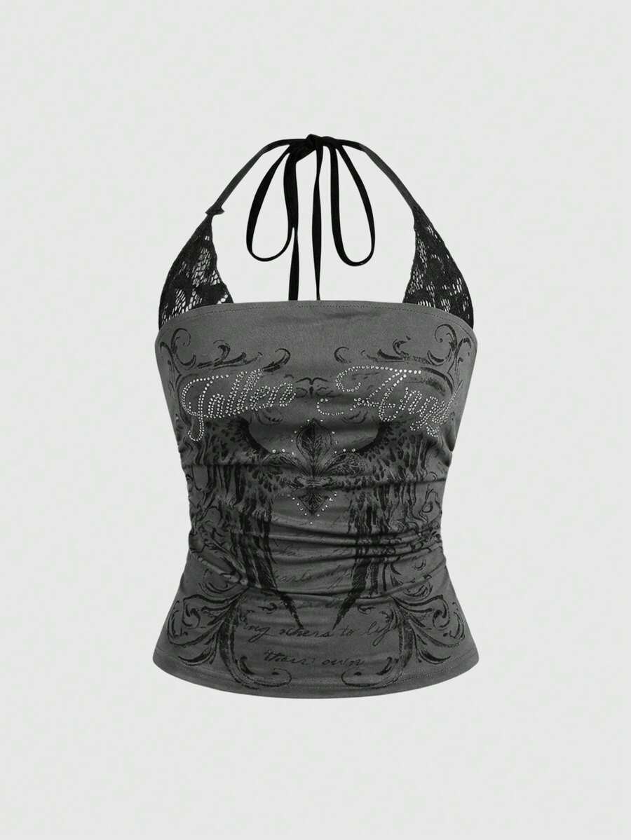 Woman wearing a black Y2K concert print 2-in-1 contrast lace halter crop top featuring a backless design with knot details.