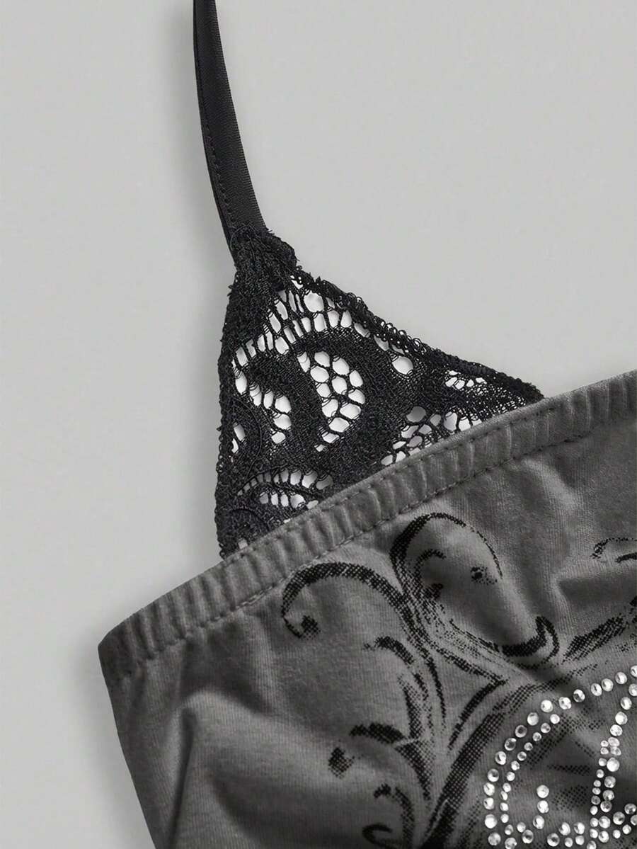 Woman wearing a black Y2K concert print 2-in-1 contrast lace halter crop top featuring a backless design with knot details.