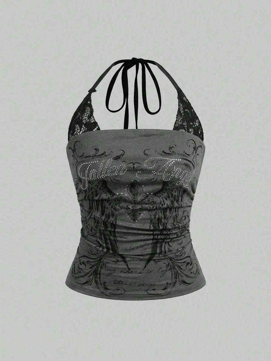 Woman wearing a black Y2K concert print 2-in-1 contrast lace halter crop top featuring a backless design with knot details.