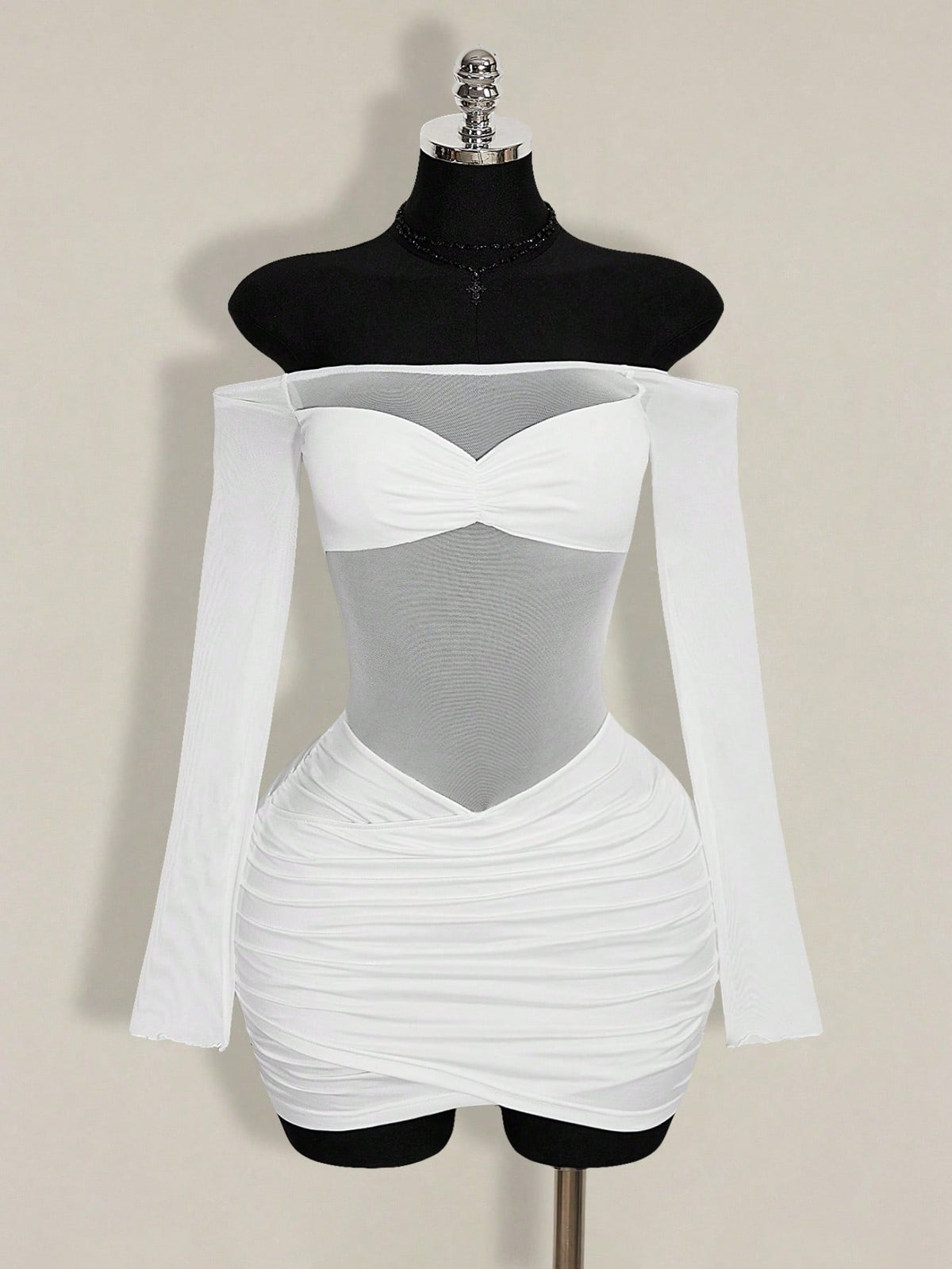 Women's black off-shoulder mini dress featuring sheer mesh patchwork details, ruched bodycon fit, and long flare sleeves.