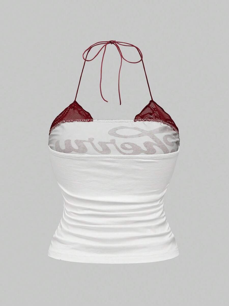 Multicolor graphic crop halter top with contrast lace trim and knot detail in a slim fit stretch knit fabric.