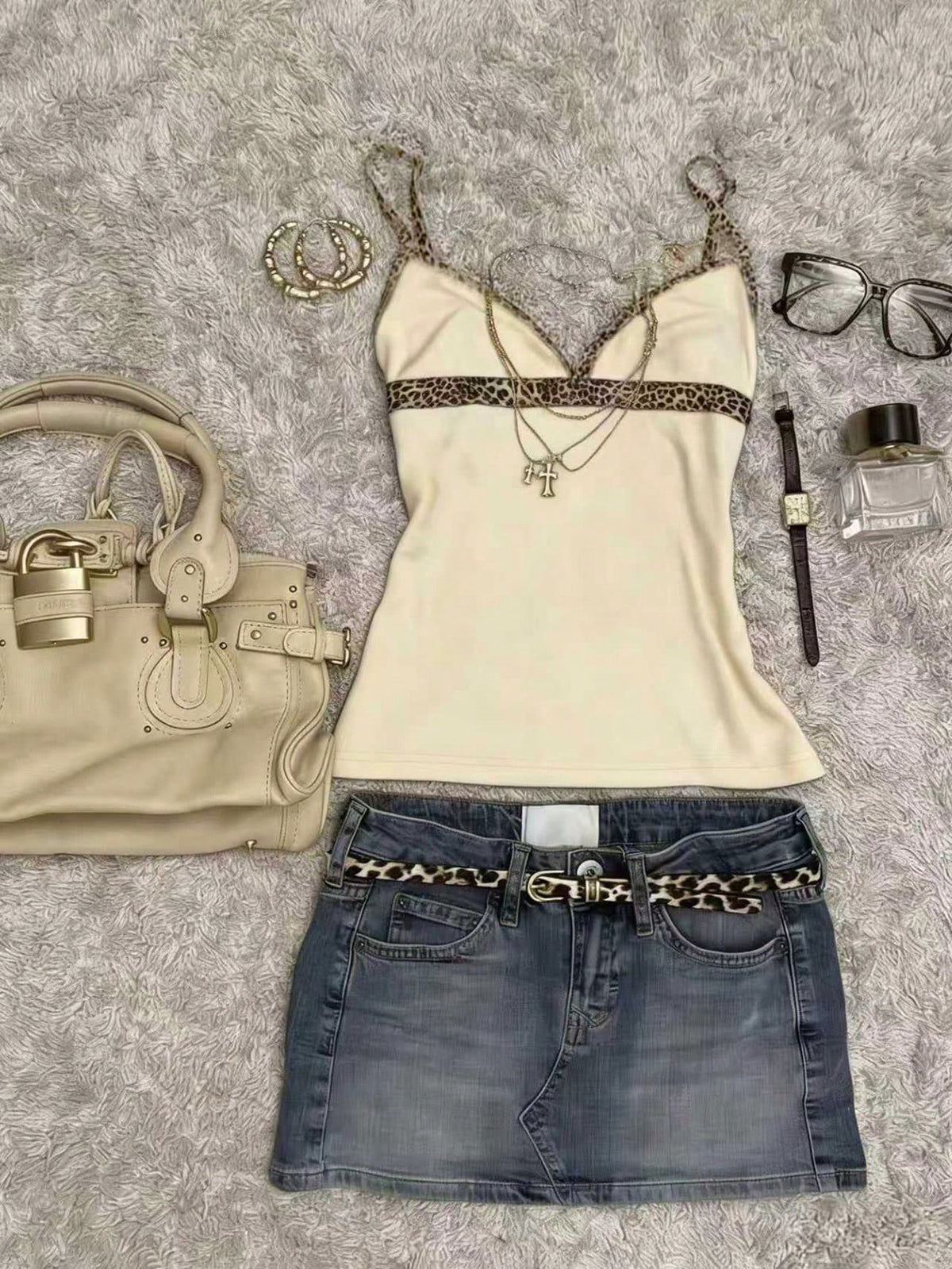 A women's solid slim fit camisole top with delicate contrast lace trim around the neckline and spaghetti straps.