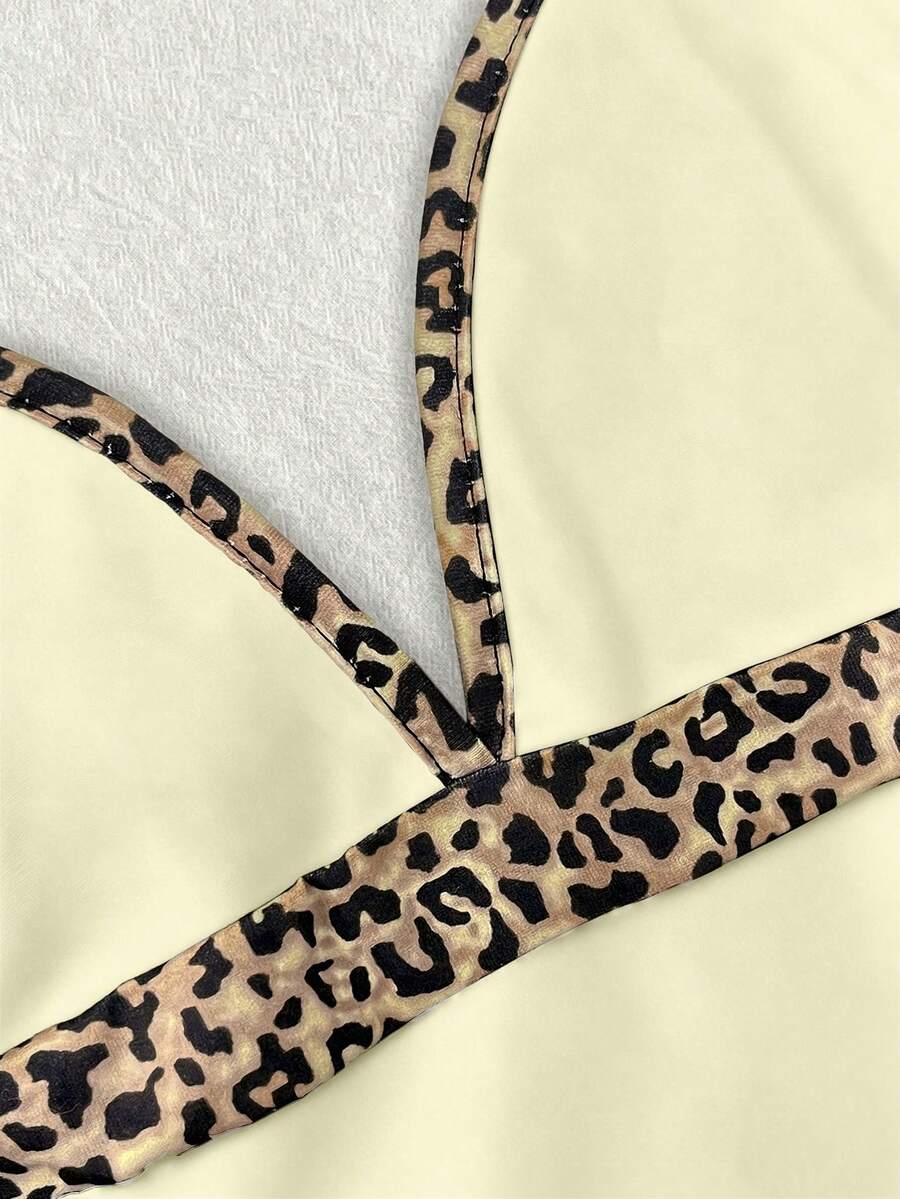 A women's solid slim fit camisole top with delicate contrast lace trim around the neckline and spaghetti straps.