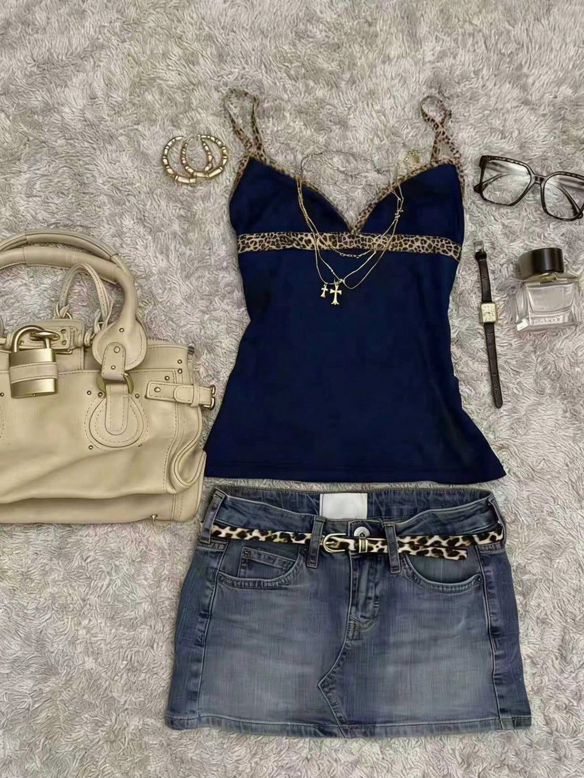 A women's solid slim fit camisole top with delicate contrast lace trim around the neckline and spaghetti straps.